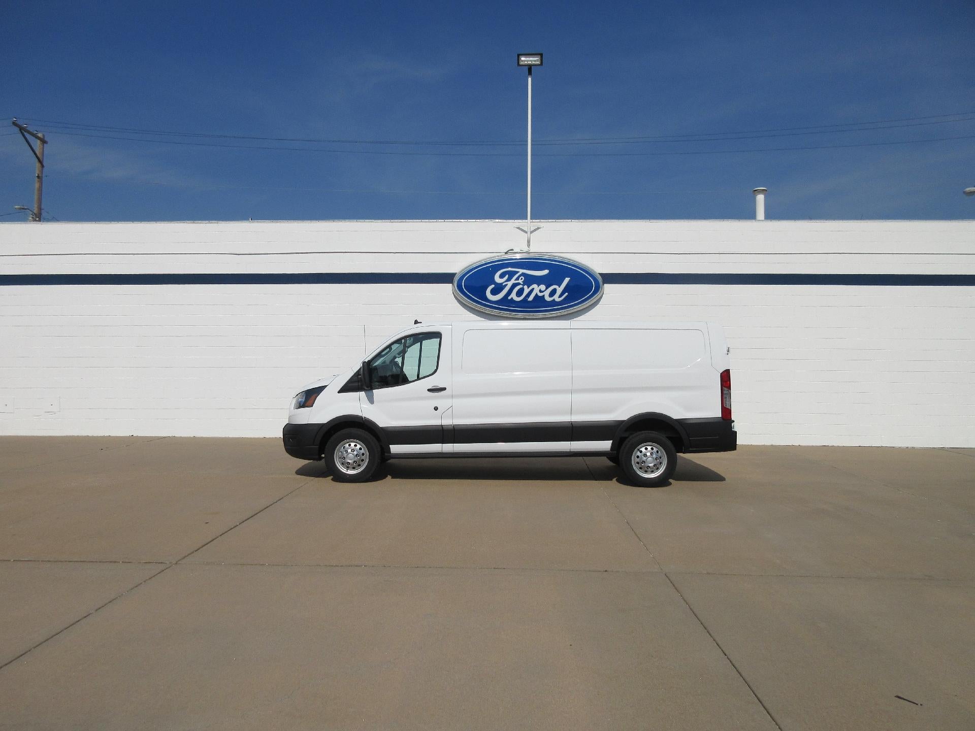2023 Ford Transit Cargo Van T-150 148" Low Rf 8670 GVWR AWD in Oxford White — front three-quarter view